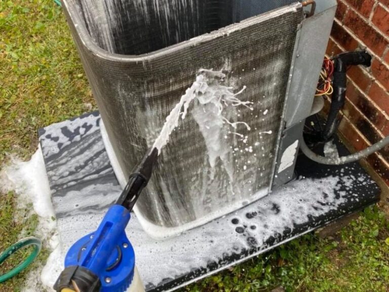 Rinsing an outdoor air conditioner condenser coil with a garden hose