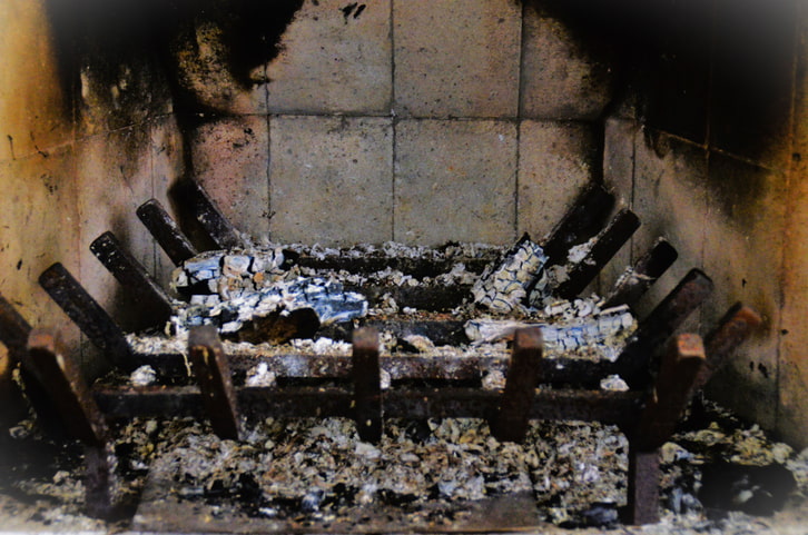 Gas fireplace burners and logs inside a home firebox